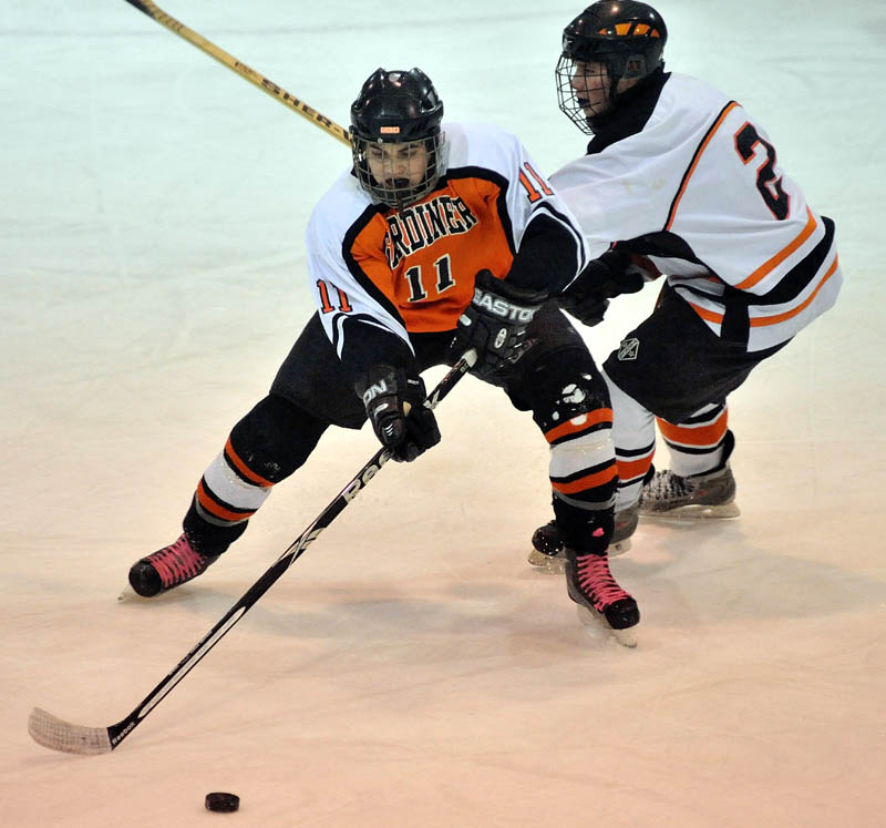 MAKE THE MOVE: Gardiner’s Bryant Whitley, left, battles for the puck with Winslow High School’s Jacob Cain in the first period Wednesday at Sukee Arena in Winslow.