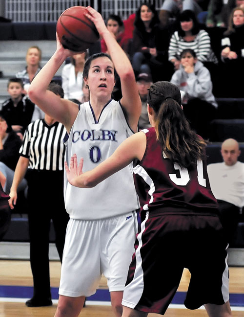 IMPACT PLAYER: Colby College’s Rachael Mack, (0) looks for her shot against Bates’ Brianna Hawkins during game Monday in Waterville. Mack scored her 1,000th point in the first quarter.