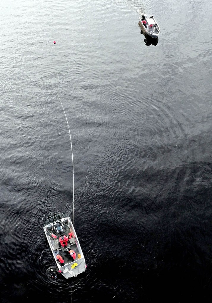 ABOVE AND BELOW: Maine Warden Service and Maine State Police divers in boats and underwater search the Kennebec River below the Carter Memorial Bridge between Waterville and Winslow on Wednesday for any signs of missing toddler Ayla Reynolds.