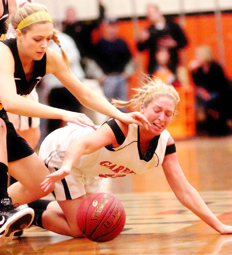 Staff photo by Joe Phelan Maranacook's Hannah Cumler, left, and Gardiner's Paige Pillsbury dive for a loose ball during a game Thursday in the James A. Bragoli Memorial Gymnasium at Gardiner Area High School.