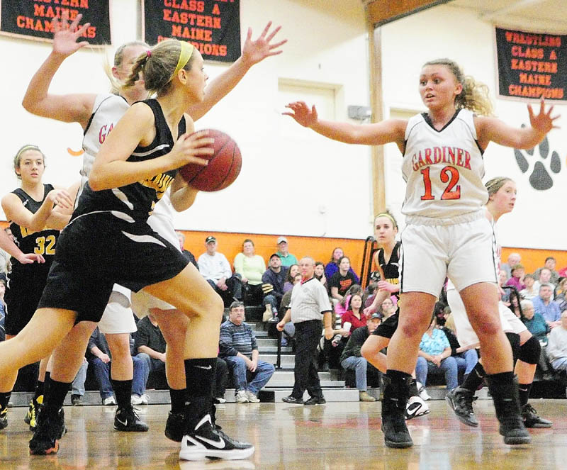 Maranacook's Hannah Cumler is guarded by Gardiner's Hillary Owen, behind her, and Taylor Bannister, right, during a game Thursday in the James A. Bragoli Memorial Gymnasium at Gardiner Area High School.