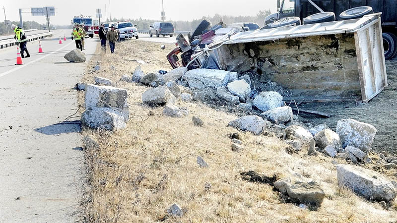 WRECK: Gouged asphalt and skid marks were left Tuesday when a dump truck overturned on the exit 113 off-ramp on Interstate 95 in Augusta. The truck was leaving the interstate and tipped over just before getting onto Route 3.