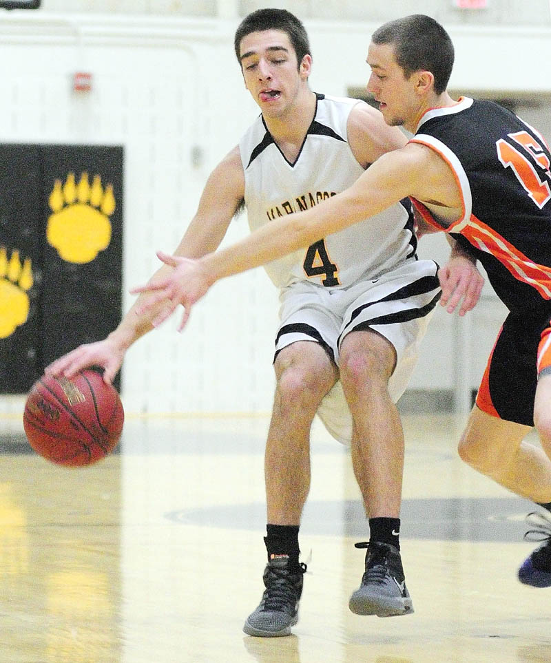 MOVE OVER: Maranacook’s Seth Miller, left, keeps the ball away from Winslow’s Brandon Labrie during a game Friday night at Maranacook Community School in Readfield.