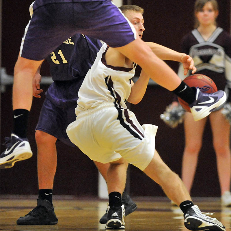 Photo by Michael G. Seamans Game action from Eastern Class B boys playoff game at Nokomis High School in Newport Wednesday night. Nokomis defeated Waterville 50-49 in overtime..