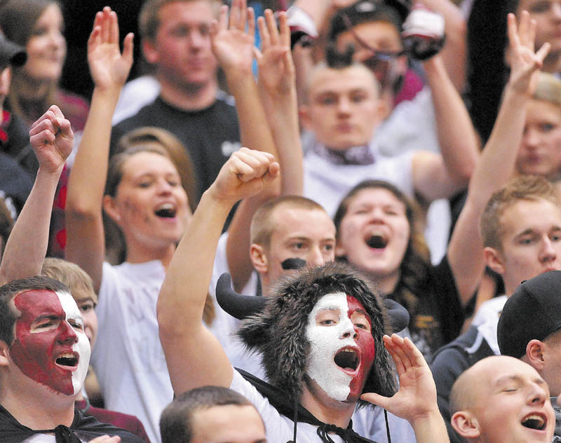 Nokomis High School senior Austin Chapman, bottom center, leads the student section in a cheer before their boys’ team played Gardiner in an Eastern B quarterfinal at the Bangor Auditorium on Friday. Nokomis lost the game in overtime, 56-47.