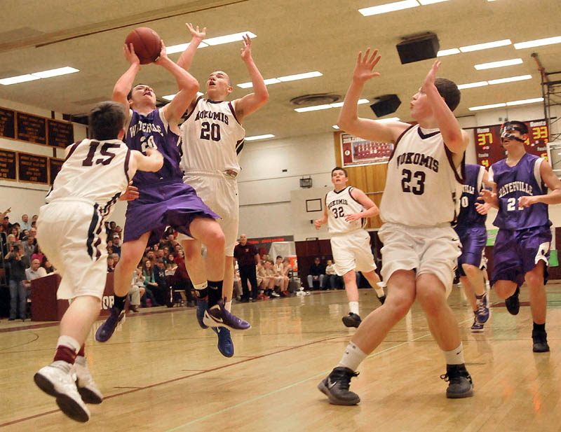 Photo by Michael G. Seamans Game action from Eastern Class B boys playoff game at Nokomis High School in Newport Wednesday night. Nokomis defeated Waterville 50-49 in overtime..