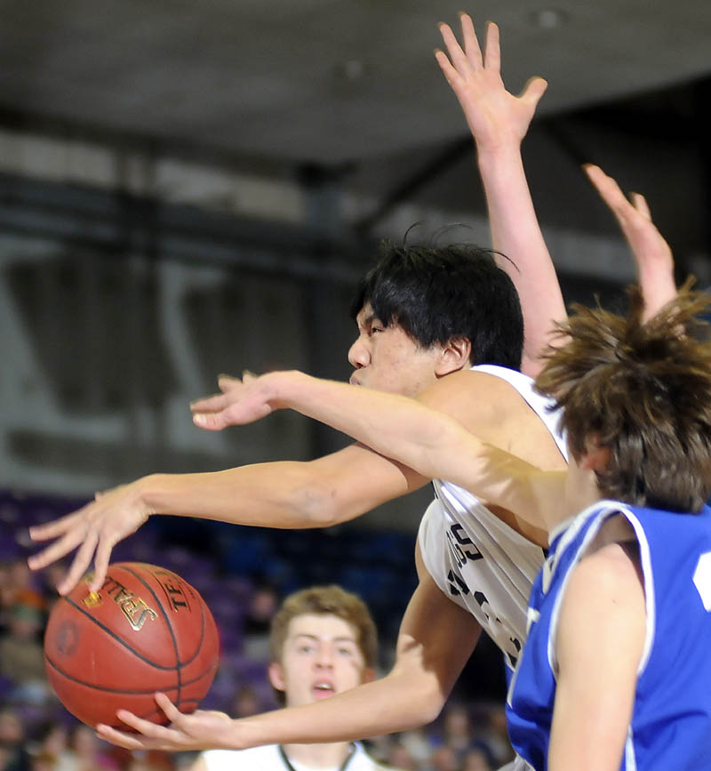 TOUGH INSIDE: Hall-Dale’s Harry Cheung drives against Madison’s MJ Flanders during a Western Maine Class C quarterfinal Monday in Augusta.