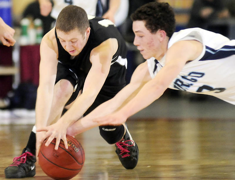 Staff photo by Andy Molloy BULLDOG BITE: Hall-Dale High School's Tyler French, left, and Dirigo High School's Caleb Turner dive for the ball during a tournament basketball match up Thursday in Augusta.