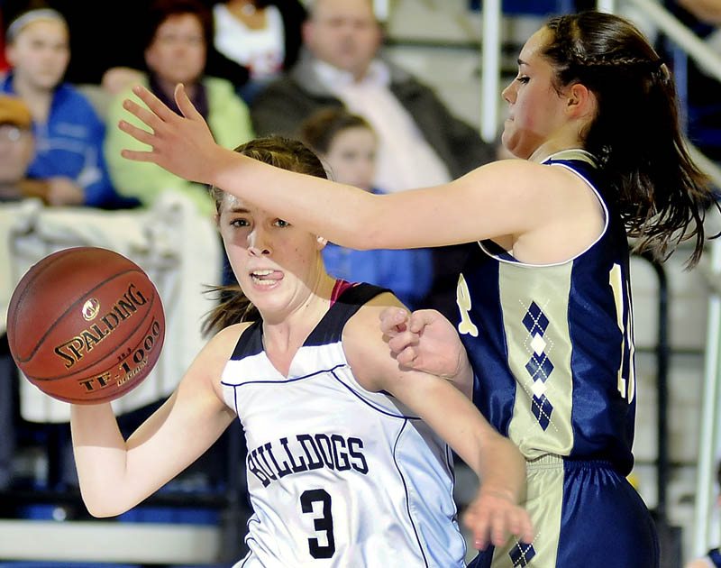 WHO’S OPEN: Hall-Dale High School’s Kristina Buck, left, gets ready to make a pass around the defense of R.W. Traip Academy’s Alli Barrett during a Western Maine Class C girls basketball semifinal Thursday at the Augusta Civic Center.
