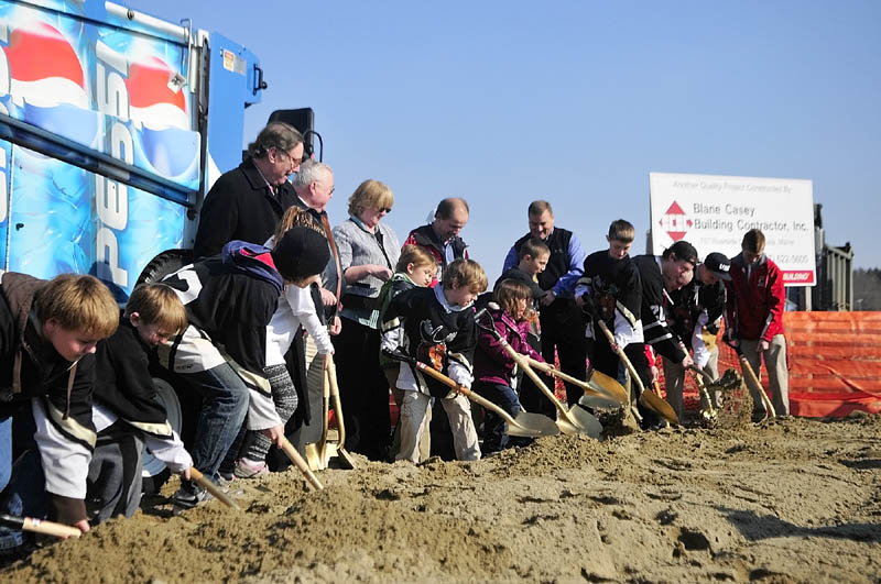 DIGGING IN: Young skaters and hockey players join in the ceremonial groundbreaking for the ice new rink, which will be called the Bank of Maine Ice Vault, on Thursday afternoon in Hallowell.
