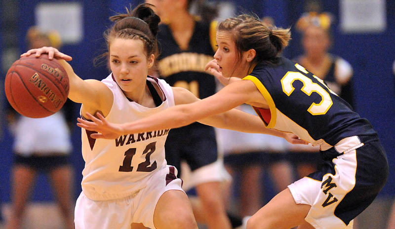 Photo by Michael G. Seamans Nokomis High School's Kylie Richards, 12, left, and Medomak Valley High School's Alanna Vose, 32, right, battle for the loose ball in the second half of the Eastern Class B quarterfinals game at the Bangor Auditorium Saturday. Nokomis defeated Medomak Valley 58-51.