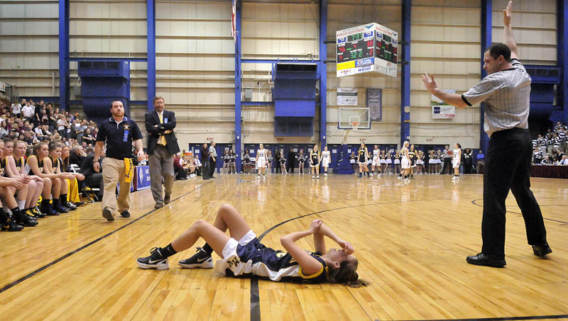 Photo by Michael G. Seamans Medomak Valley High School's Alanna Vose, 32, holds her elbow and head after injuring herself in the second half of the Eastern Class B quarterfinals game at the Bangor Auditorium Saturday. Nokomis defeated Medomak Valley 58-51.