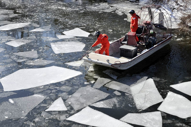 Authorities clear Messalonskee Stream of ice under the North Street bridge as they prepare to continue the search for Ayla Reynolds on Friday. Dive teams from the Maine Warden Service and Maine State Police returned to Waterville Friday to resume the search for clues to the disapperance of 22-month-old Ayla Reynolds.