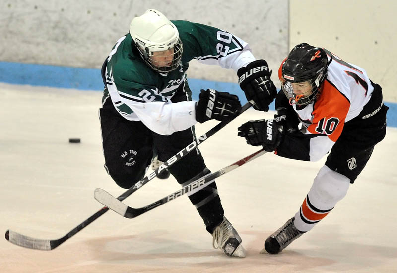 CRASH COURSE: Old Town High School’s Peter Wilcox, left, checks Skowhegan’s Jake Johnson during the first period Wednesday night at Sukee Arena in Winslow. Johnson assisted on the final goal in Skowhegan’s 3-0 victory.