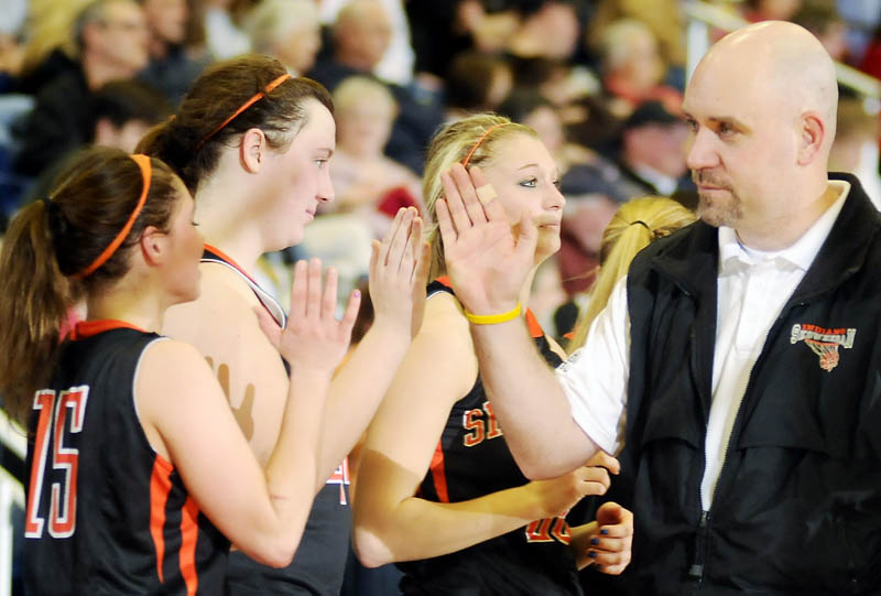 GOOD RUN: Skowhegan Area High School girls basketball coach Heath Cowan high-fives his bench as the clock ticks down during an Eastern Maine Class A semifinal Wednesday at the Augusta Civic Center. Skowhegan lost 54-34.
