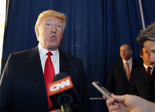 Donald Trump talks to reporters today prior to a news conference in which he announced his endorsement of Mitt Romney for president.