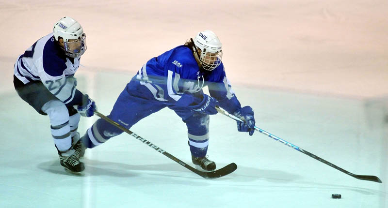 ON THE CHASE: University of New England’s Matt DelGiudice, right, skates past Colby College’s Cory McGrath in the first period Tuesday at Colby College’s Alfond Arena in Waterville.