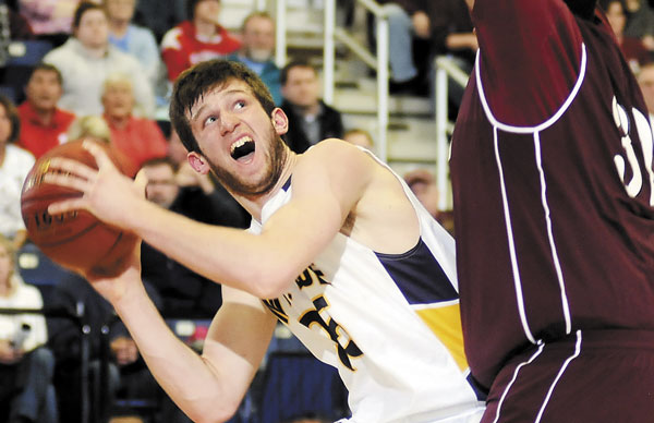 TOUGH TO SEE: Mt. Blue High School’s Cam Sennick, left, looks for space around Edward Little’s Aaron Crenshaw during an Eastern Maine Class A semifinal Wednesday night at the Augusta Civic Center. Mt. Blue won 52-49 and advanced to the regional final at 8:45 p.m. Friday.