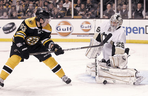 STOPPED: Pittsburgh goalie Marc-Andre Fleury stops a shot by Boston’s Brad Marchand during the second period Saturday in Boston.