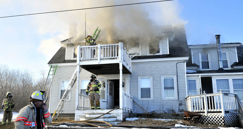 FIRE DAMAGE: Firefighters from four departments battle a fire that caused serious damage to the Charles Stubenrod home on Gogan Road in Benton on Thursday. Stubenrod said he may have accidentally caused the fire after soldering heat pipes an hour before the fire.