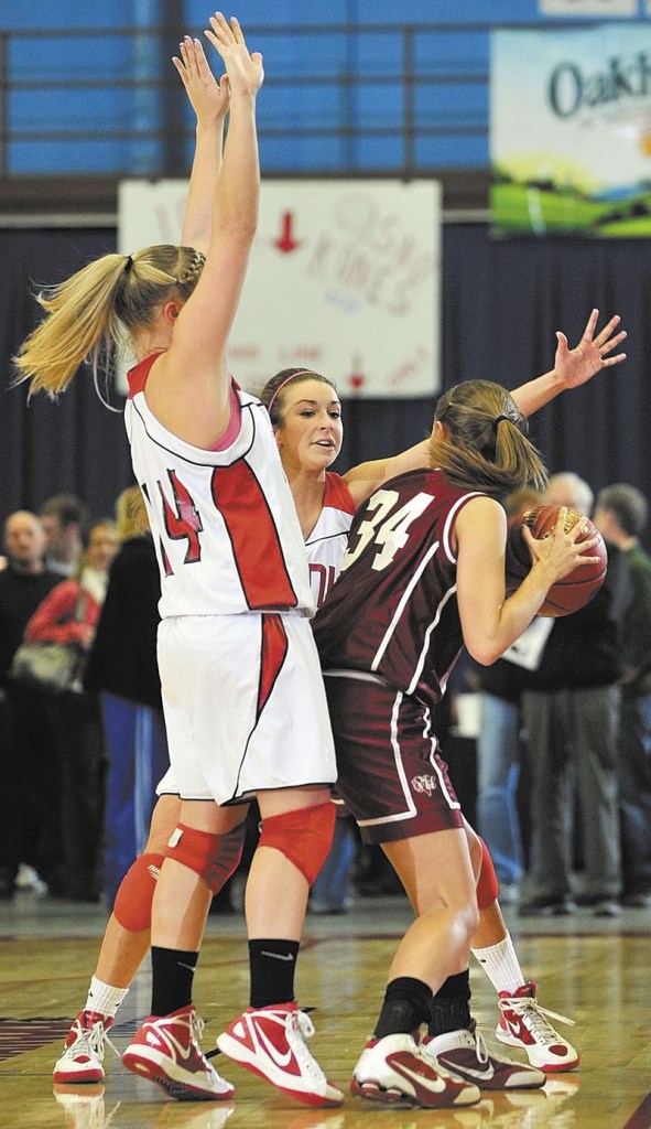 Staff photo by Joe Phelan Cony's Alyssah Dennett, left, and Josie Lee double team Bangor's Jordan Seekins during the Class A East tournament on Friday night at the Augusta Civic Center. richmond buckfield standish softball