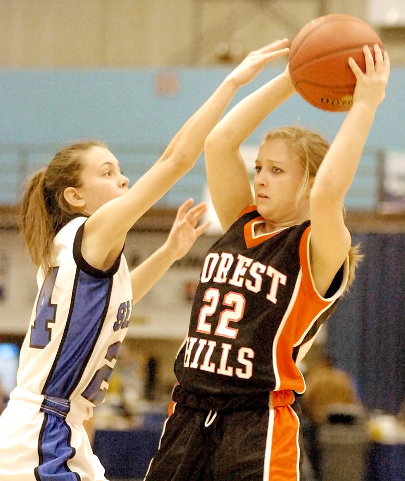 Seacoast's Jenny English, left, tries to block Forest Hills' Dana McNally during the Class D West tournament on Tuesday morning at the Augusta Civic Center.