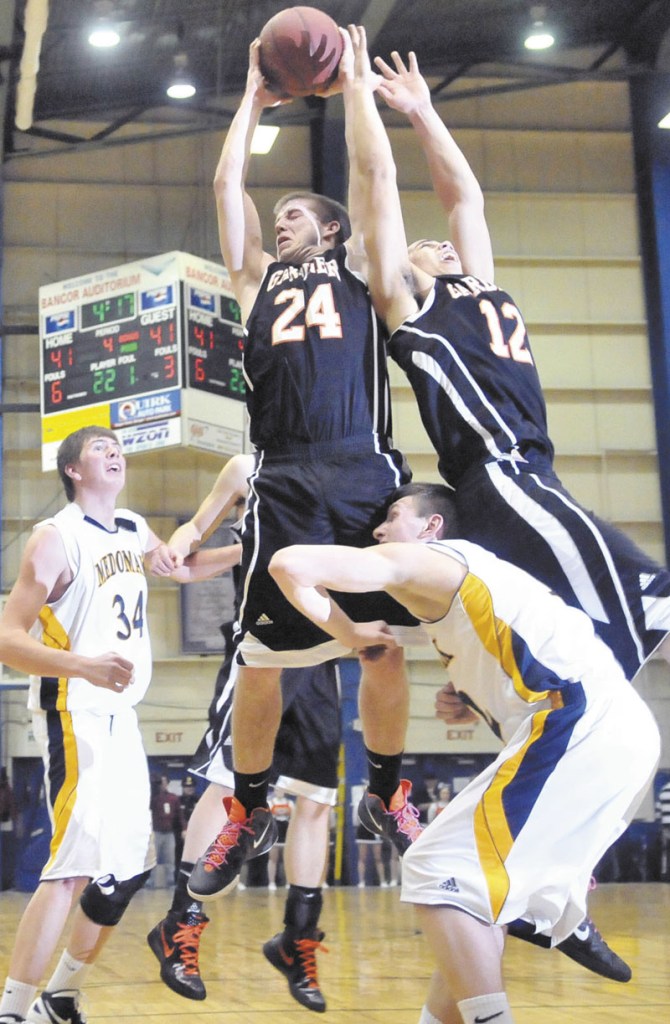BIG BOARD: Gardiner High School’s Matt Hall, 24, left center, grabs the rebound in the second half of the Eastern Class B semi-finals at the Bangor Auditorium Wednesday. Gardiner defeated Medomak Valley 57-46.