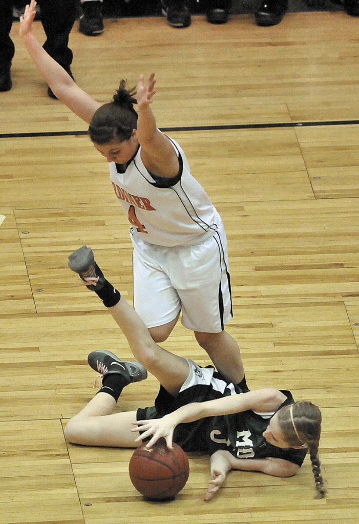 Photo by Michael G. Seamans Gardiner High School's Kylee Granholm, 4, top, tries to avoid Mount Desert Island High School's Sarah Phelps, 5, bottom, after Phelps lost control of the ball in the first half of the Eastern Class B quarterfinals game at the Bangor Auditorium Saturday. Gardiner defeated MDI 63-38.
