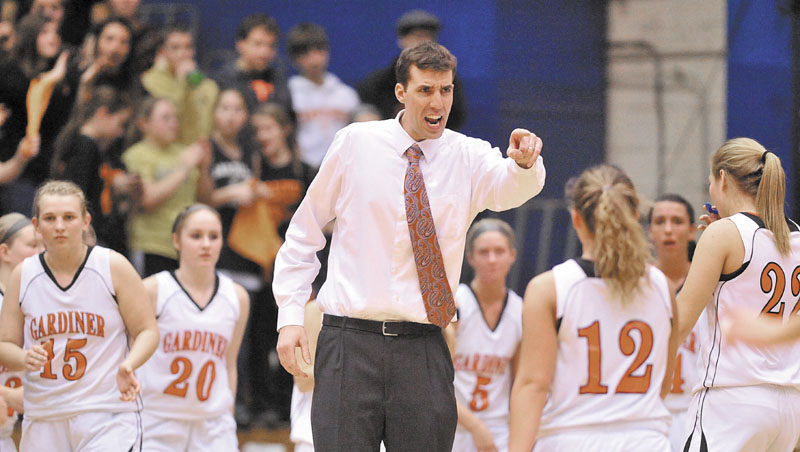 Gardiner High School head coach Mike Gray, center, celebrates with his team during a time out in the second half of the Eastern Class B quarterfinals game at the Bangor Auditorium Saturday. Gardiner defeated MDI 63-38.