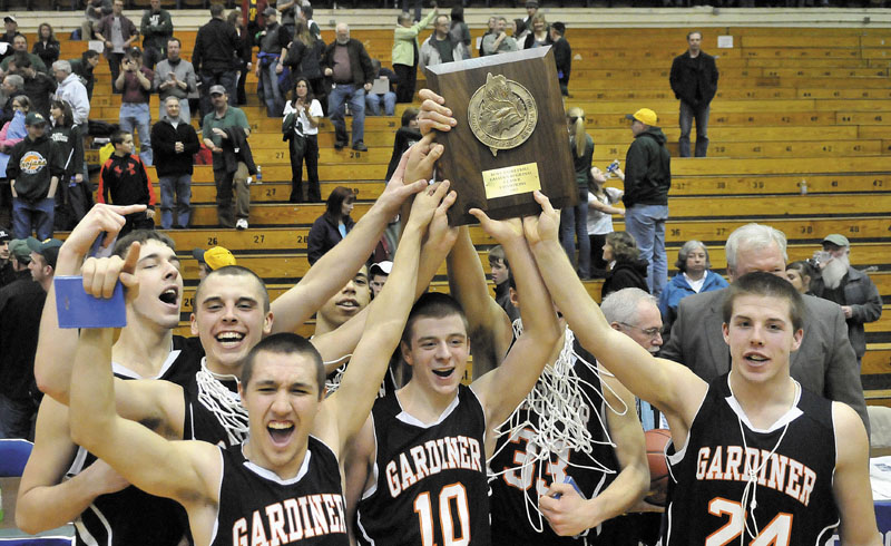 RAISE THE PLAQUE: Gardiner Area High School’s (from left to right) Tyler Jamison, Jake Palmer, Travis Kelley, Justin Lovely, Aaron Toman and Matt Hall celebrate after defeating Mt. Desert Island 70-58 for the Eastern Maine Class B championship Saturday at the Bangor Auditorium.