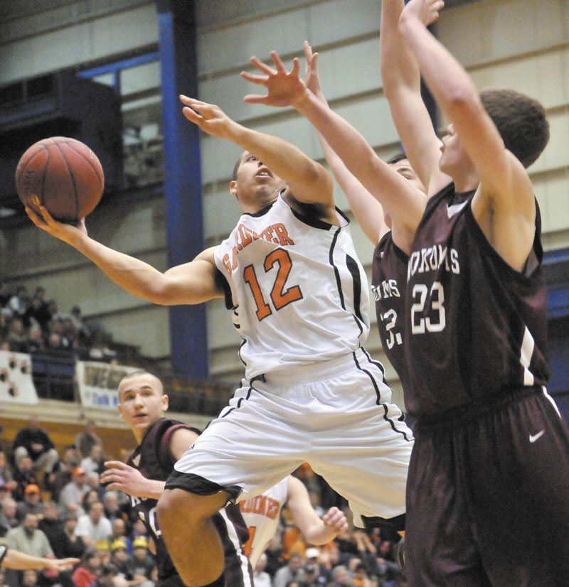 GO UP STRONG: Gardiner’s Alonzo Connor, left, drives to the hoop against Nokomis defenders Chandler Foss, center, and Andrew Cartright in the first half of the Eastern Class B quarterfinals game Friday at the Bangor Auditorium. Gardiner won 56-47 in overtime.