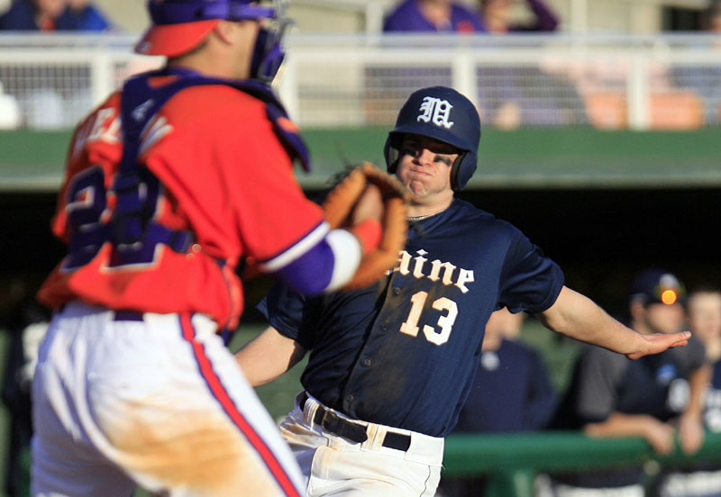 A SOLID START: Maine’s Alex Calbick slides into home as Clemson catcher Spencer Kieboom waits for the ball during their game Friday in Clemson, S.C. Maine showed its strength last weekend at 16th-ranked Clemson, with three competitive games, one of them a victory.