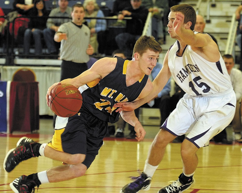 Mt. Blue's Eric Berry tries to dribble past Hampden Academy's Cam Scott during the Class A East championship game on Friday night at the Augusta Civic Center.