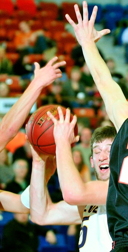Mt. Blue's Cam Sennick, center, is swarmed by Brunswick defenders during the Class A East tournament on Saturday afternoon at the Augusta Civic Center.