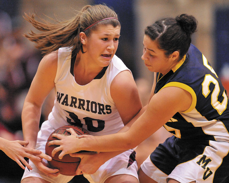 Nokomis High School's Anna Mackenzie, 30, left, and Medomak Valley High School's Amanda Hendrickson-Belloguet, 25, fight for the ball in the second half of the Eastern Class B quarterfinals game at the Bangor Auditorium Saturday. Nokomis defeated Medomak Valley 58-51.