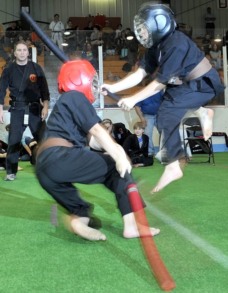 ARTIST AT WORK: Kyle Anderson, 12, of Clinton, right, jumps as he attacks CJ Rumsey, 11, of Winslow, during a chambara bout during the Battle of Maine Martial Arts competition Saturday at Sukee Arena in Winslow.