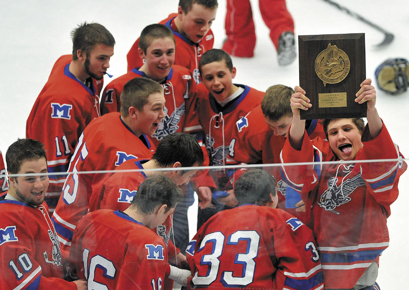 WAY TO GO: Messalonskee players celebrate around head coach Mike Latendresse after they won the Eastern Maine Class B title with a 5-2 win over Brewer on Tuesday night at the Unviersity of Maine in Orono.