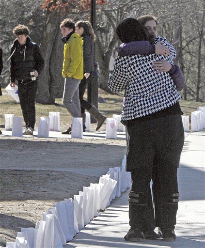 People hug at St. Johnsbury Academy today in St. Johnsbury, Vt. The discovery of a body believed to be teacher Melissa Jenkins has sent shudders of grief and anxiety through the small New England town.