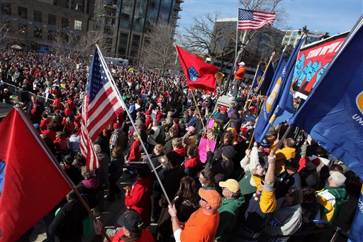 Labor groups and others rally in front of the state capitol building in Madison, Wis. to recall Wisconsin Gov. Scott Walker in this March 10, 2012, photo.