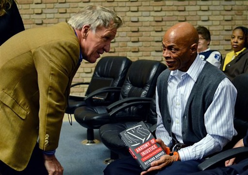 Author Raymond Bonner, left, speaks to Edward Lee Elmore before his hearing on Friday, March 2, 2012 in Greenwood, S.C. Elmore, who spent 30 years in prison for murdering Dorothy Edwards, a crime that Elmore said he did not commit, was set free by Judge Frank Addy on Friday. (AP Photo/ Richard Shiro)