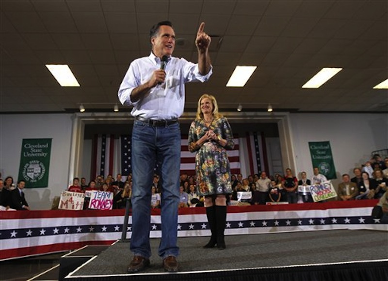 Republican presidential candidate Mitt Romney speaks with his wife, Ann, at a campaign rally in Cleveland, Friday, March 2, 2012. (AP Photo/Gerald Herbert)