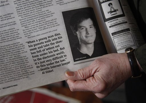 Karen Williams of Beaverton, Ore., holds a newspaper clipping about her son Loren Williams, who died in a motorcycle crash.