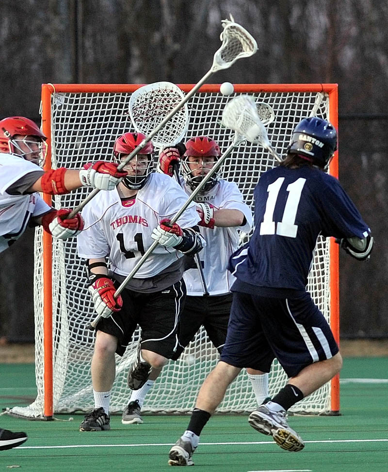 TAKE THE SHOT: SUNY Canton’s Pat Connelly (11) scores on a shot through Thomas College defenders Isaac Brown, far left, Samuel Rothman, left center, and goalie Jesse Morkeski on Wednesday at Bill Alfond Field at Colby College in Waterville.