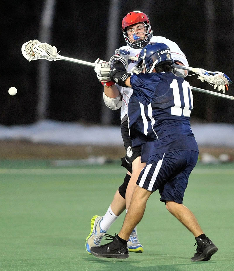 Photo by Michael G. Seamans Thomas College's Tyler Mitchell, 21, facing, collides with SUNY Canton's Trevor Roundpoint, 10, in the first period at Bill Alfond Field at Colby College in Waterville Wednesday night.