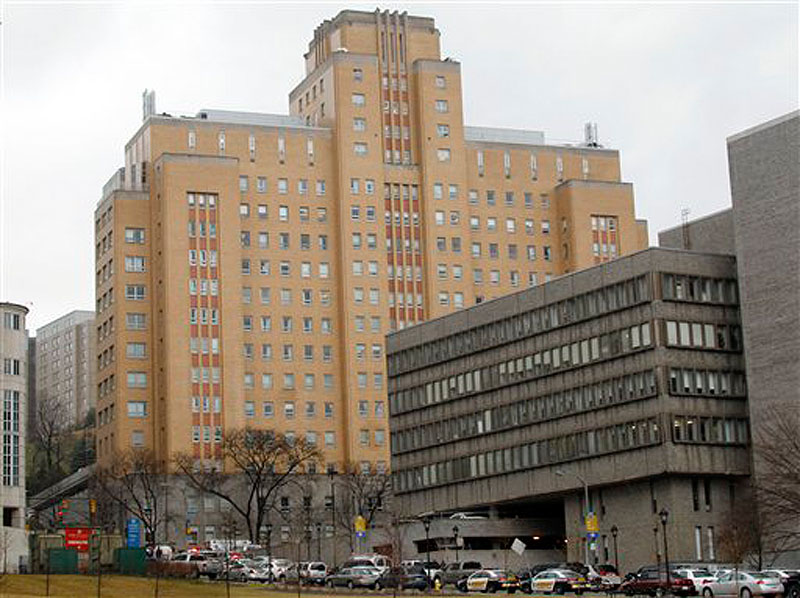 Police line O'Hara street near the front entrance to the Western Psychiatric Institute and Clinic, tan building, on the University of Pittsburgh campus on Thursday, March 8, 2012 in Pittsburgh. Two people died and seven were injured after a gunman open fired in the clinic. (AP Photo/Keith Srakocic)