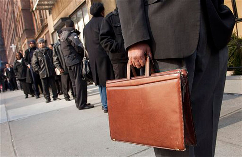 Dozens of job seekers line up to enter a National Career Fair on Wednesday, Feb. 22, 2012 in New York. The number of people seeking unemployment aid stayed at a four-year low last week, the latest evidence that layoffs are low and the job market is slowly healing. (AP Photo/Mark Lennihan)