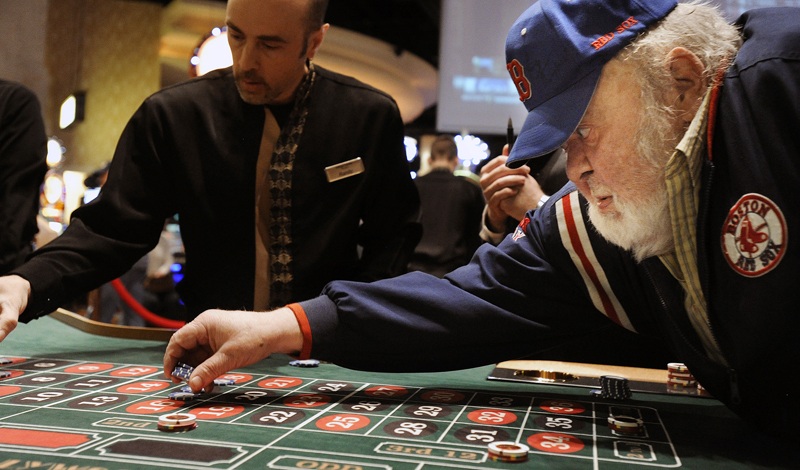 Gerry Beckwith of Hampden places a bet at the roulette table at Hollywood Casino in Bangor this morning.