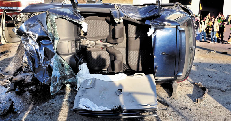 CRASH SCENE: The demolished overturned vehicle that Nancy Hazard was driving after she plowed into five vehicles parked at a traffic light in Waterville on Sunday, sending six people to the hospital. Police say she was operating at a high rate of speed on College Avenue.