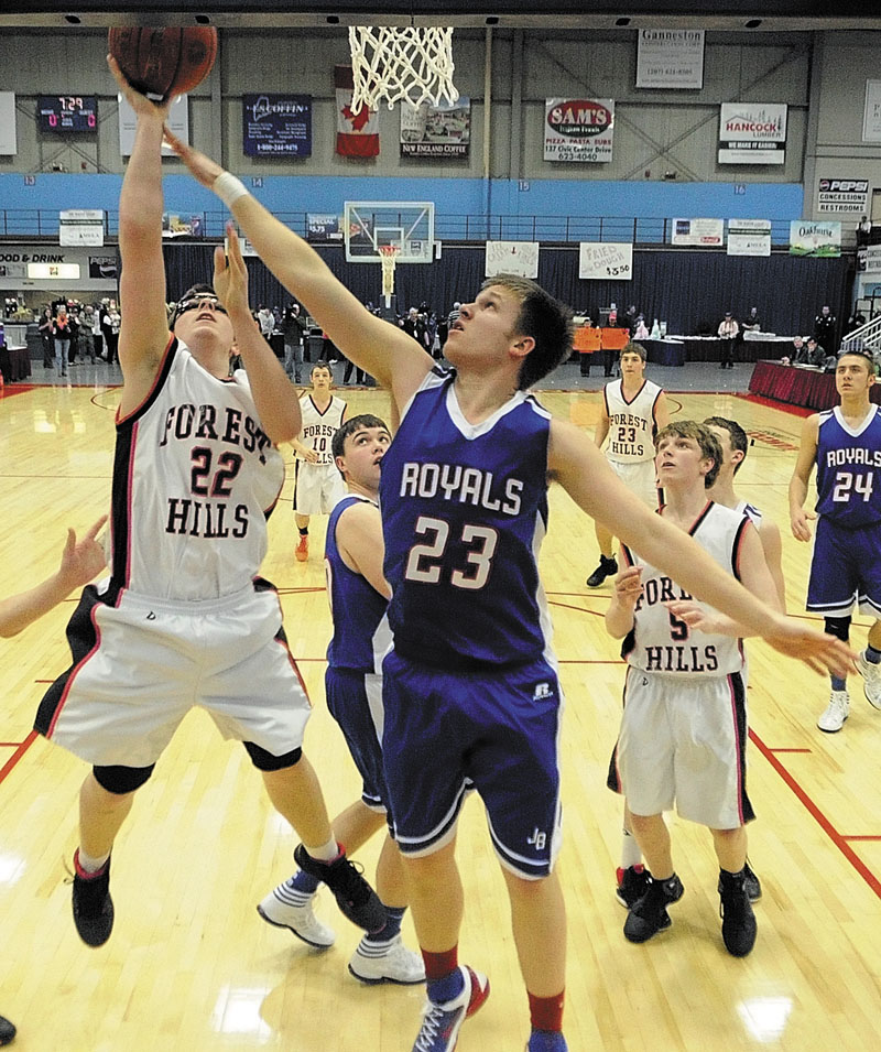 Forest Hills junior guard Derick Ouellette, 22, left, takes a shot over Jonesport-Beals senior forward Justin Alley during the Class D state championship game on Saturday afternoon at the Augusta Civic Center.