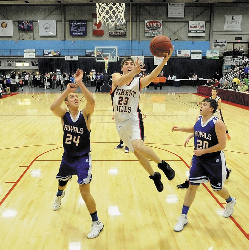 Forest Hills junior forward Evan Worster, middle, drives to the hoop between Jonesport-Beals defenders Garet Beal, left, and Vinal Crowly during the Class D state championship game on Saturday afternoon at the Augusta Civic Center.